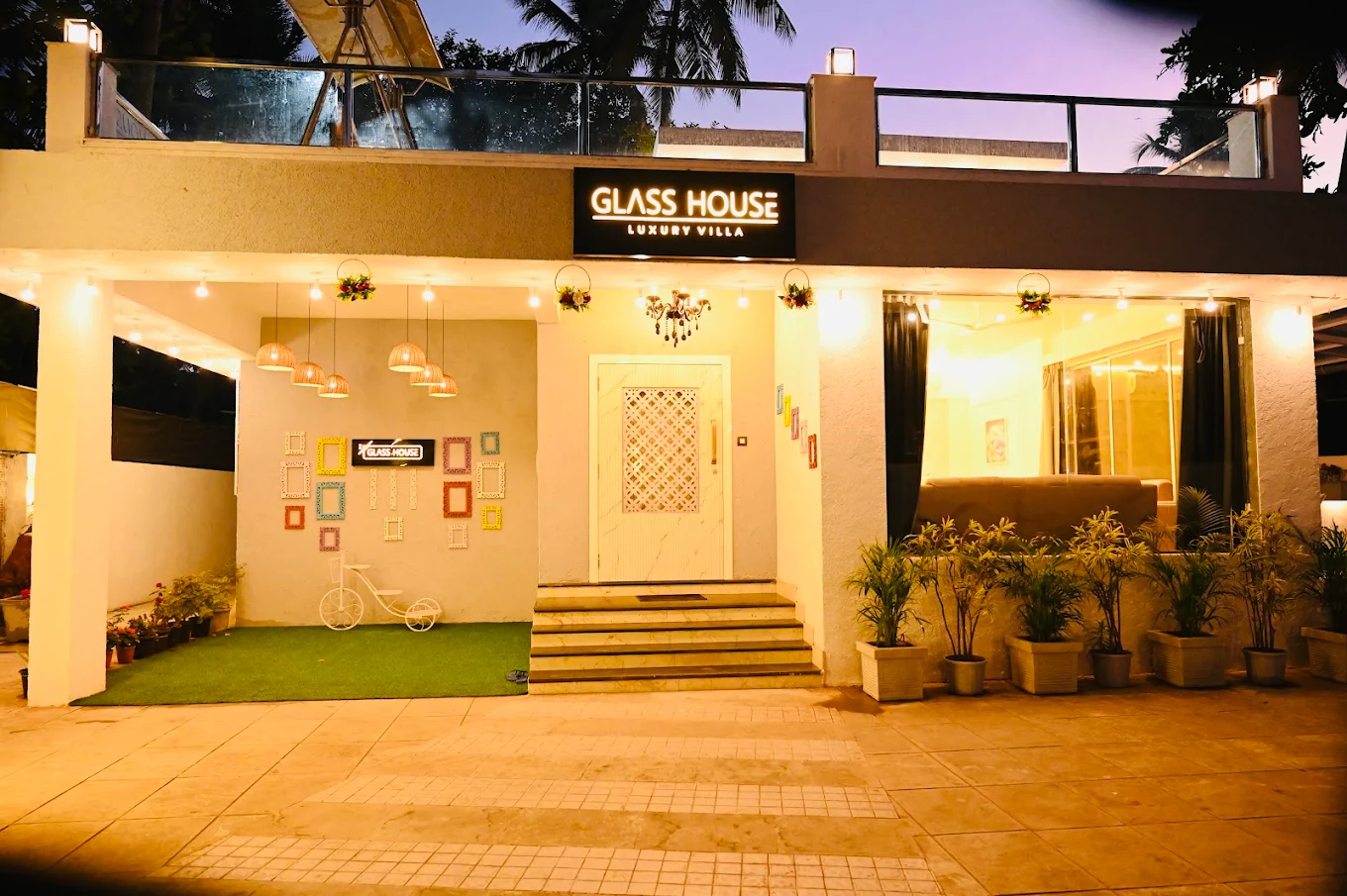 Glass House Luxury Villa illuminated at dusk