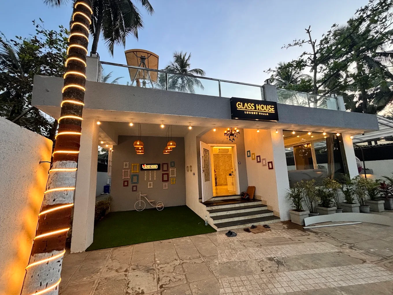 Glass House Luxury Villa illuminated at dusk