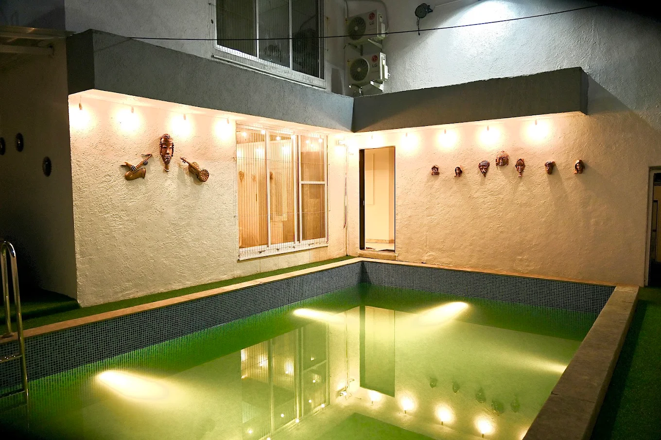 Glass House Luxury Villa illuminated at dusk